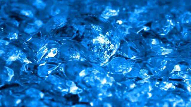 Boiling Bright Blue Liquid. Intense seething. Slow motion boiling water, painted Bright Blue