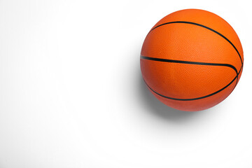 Orange ball on white background, top view. Basketball equipment