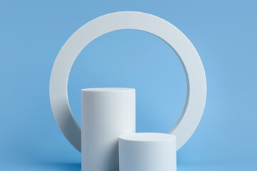 White podium to show cosmetic products with geometric forms on blue background. Background for...