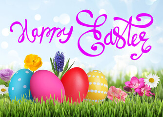 Happy Easter. Bright eggs and spring flowers on green grass outdoors