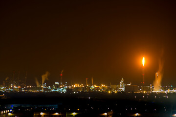 Petrochemical factory with flame at night