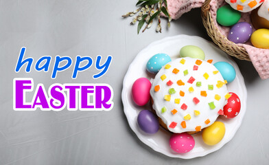Fototapeta na wymiar Happy holiday. Easter cake and painted eggs on light grey table, flat lay
