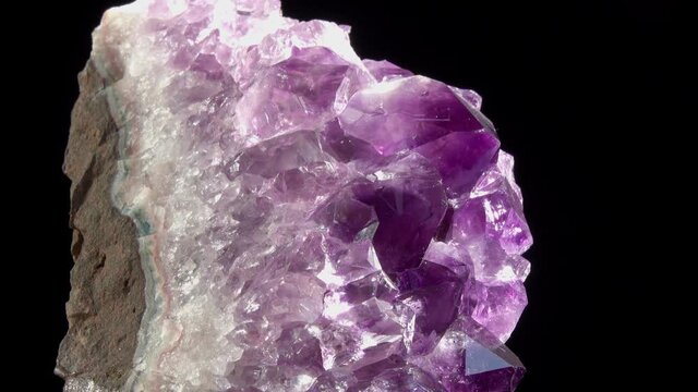 Druse of Violet Amethyst Crystals. Footage of Violet Crystal Stone macro mineral against a dark background. Crystal druse rotation in the frame