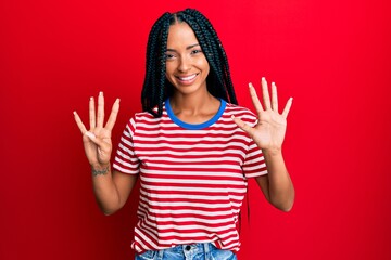 Beautiful hispanic woman wearing casual clothes showing and pointing up with fingers number nine...