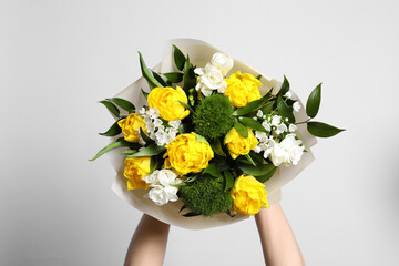 Woman with bouquet of beautiful tulips on white background, closeup
