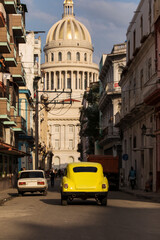 Fototapeta na wymiar Amazing old american car on streets of Havana with Capitolio Building in background during the day. Havana, Cuba.