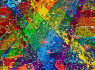 Tracery. Variegated spheres of different diameters are located on a tabby rainbow background....