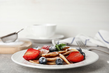 Cereal pancakes with berries on light grey table