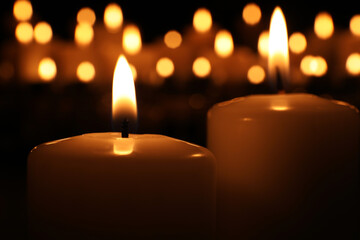 Burning candles in darkness, closeup. Memory day