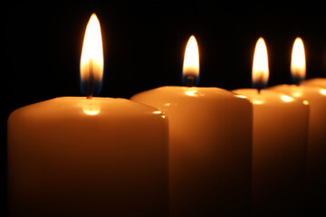 Many burning candles on black background, closeup.  Memory day