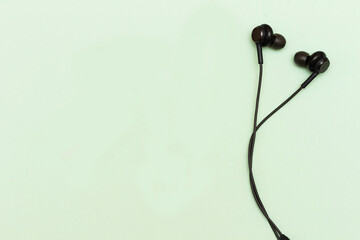 black Earphones on green background. Music is my life concept