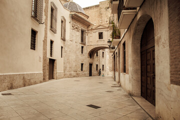 Old, stone-walled city streets in Valencia, Spain