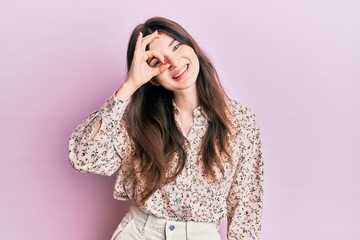 Young beautiful caucasian girl wearing elegant clothes smiling happy doing ok sign with hand on eye looking through fingers