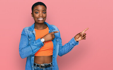 Young african american woman wearing casual clothes pointing aside worried and nervous with both hands, concerned and surprised expression