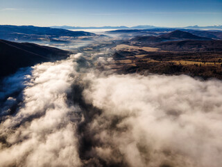 Beautiful view from above the clouds with blue sky in background.