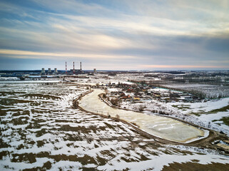 Snow melting, Season change. Gas power plant near big city Minsk, Belarus.