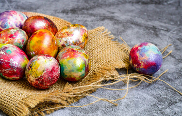 Colorful hand painted purple and rose  easter eggs and  spring blossom on wooden background