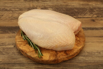 Raw whole chicken breast with skin