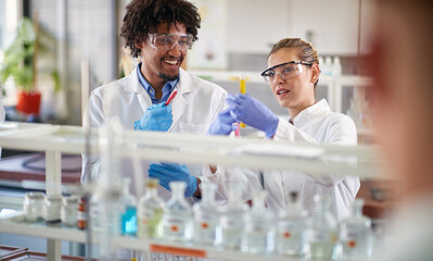 Two young medical students conducting chemical experiment