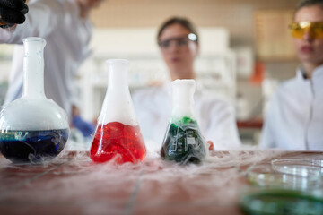 Laborant technicians conducting chemical reactions experiment