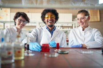 Young chemistry students have fun working with chemicals in the university laboratory. Science, chemistry, lab, people