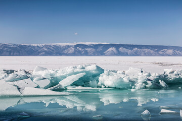 View of the frozen Lake Baikal with ice hummocks on a sunny winter day. Russia