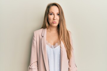 Obraz premium Young blonde woman wearing business jacket and glasses depressed and worry for distress, crying angry and afraid. sad expression.