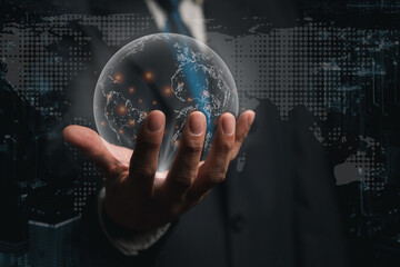 Business man holding hologram of globe with world map background