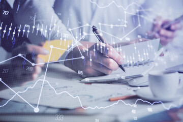 Double exposure of forex graph drawing over people taking notes background. Concept of financial analysis