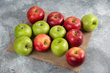 Bunch of fresh green and red apples placed on burlap