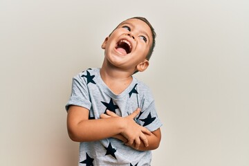 Adorable latin toddler wearing casual clothes looking to side, relax profile pose with natural face...