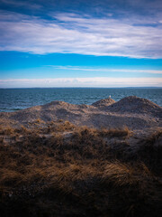 Cloudy Seascape over the Erosion Control Sand Piles and Grass Hills in the Vineyard Sound in Massachusetts, USA