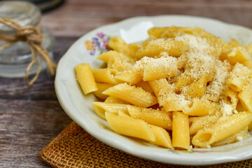  Home made  italian penne rigate pasta  with parmesan cheese,garlic  and black pepper .Pasta cacio e pepe. 