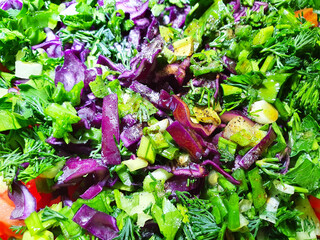 Spring vitamin salad of beetroot cabbage and dill, onion, cucumber, parsley. Close-up view	
