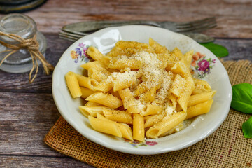  Home made  italian penne rigate pasta  with parmesan cheese,garlic  and black pepper .Pasta cacio e pepe. 