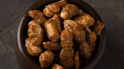 Top view of caramelized Peanuts ion concrete background. sweet snack cocnept.Close up