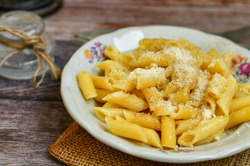  Home made  italian penne rigate pasta  with parmesan cheese,garlic  and black pepper .Pasta cacio e pepe. 