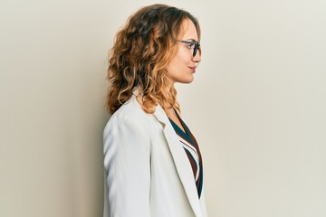 Young caucasian woman wearing business style and glasses looking to side, relax profile pose with...