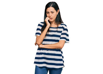 Beautiful young woman wearing casual clothes looking stressed and nervous with hands on mouth...