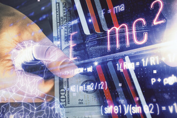 Multi exposure of Formulas drawing hologram and USA dollars bills and man hands. Education