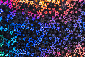 Naklejka na ściany i meble Pearlescent stars shimmer in different shades, starry bokeh, background
