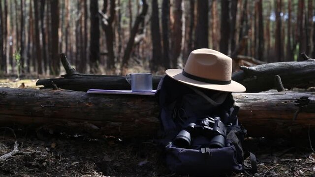 Tourist s backpack, binoculars, a map and equipment for a hike