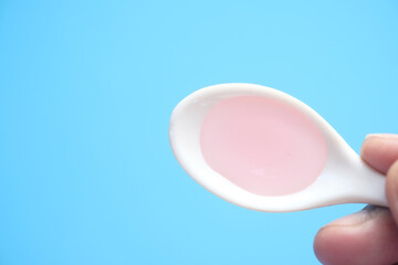 pour liquid medicine on top of spoon 