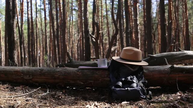 Tourist s backpack, binoculars, a map and equipment for a hike