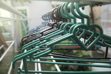 a group of clotheslines hanger hanging in the drying aluminum clothes in the yard of the house