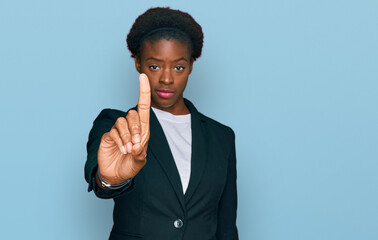 Young african american girl wearing business clothes pointing with finger up and angry expression,...