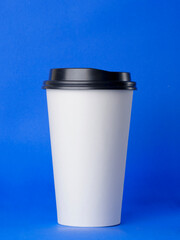 Take away concept. orange takeaway cup .coffee on blue background, coffee takeaway