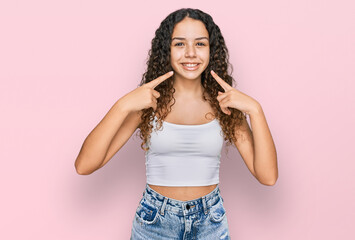 Teenager hispanic girl wearing casual clothes smiling cheerful showing and pointing with fingers...