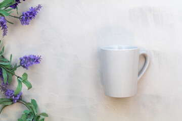 White mug mockup and lilac on gray watercolor background flat lay copy space