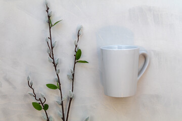 Obraz na płótnie Canvas White mug mockup and willow branches on gray watercolor background flat lay copy space